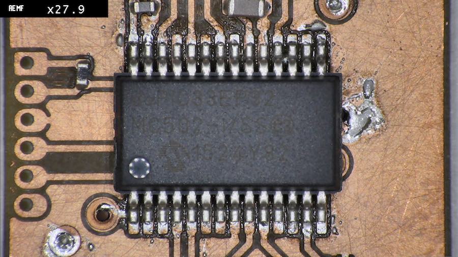 the PIC under the microscope, soldered relatively cleanly and without any bridges