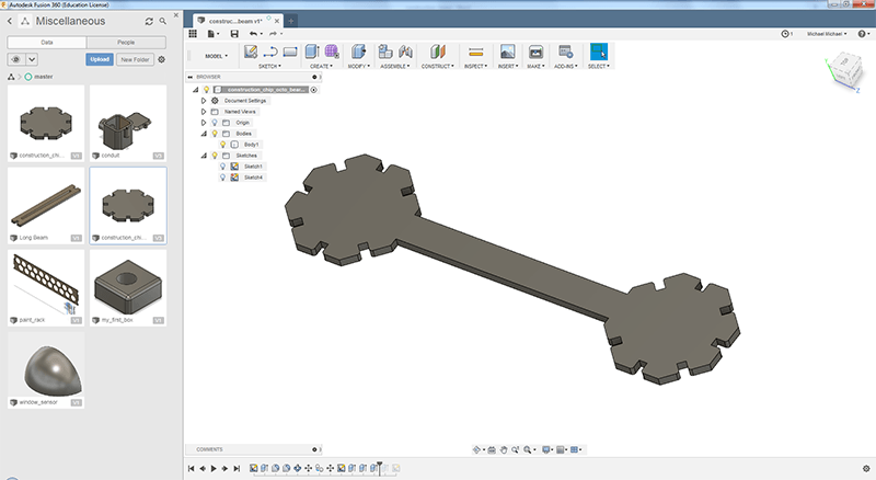 3D render of two octogon-shaped construction chips connected with a beam.